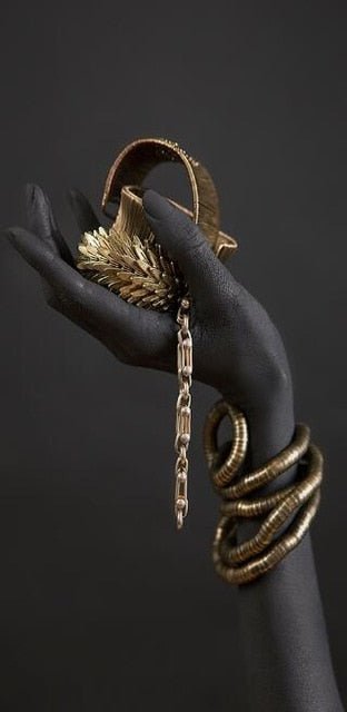 Hands intertwined with gold objects